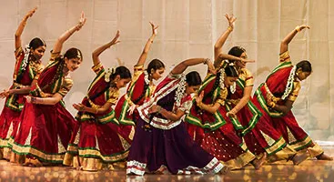 SSR students performing a group routine on stage in matching costumes